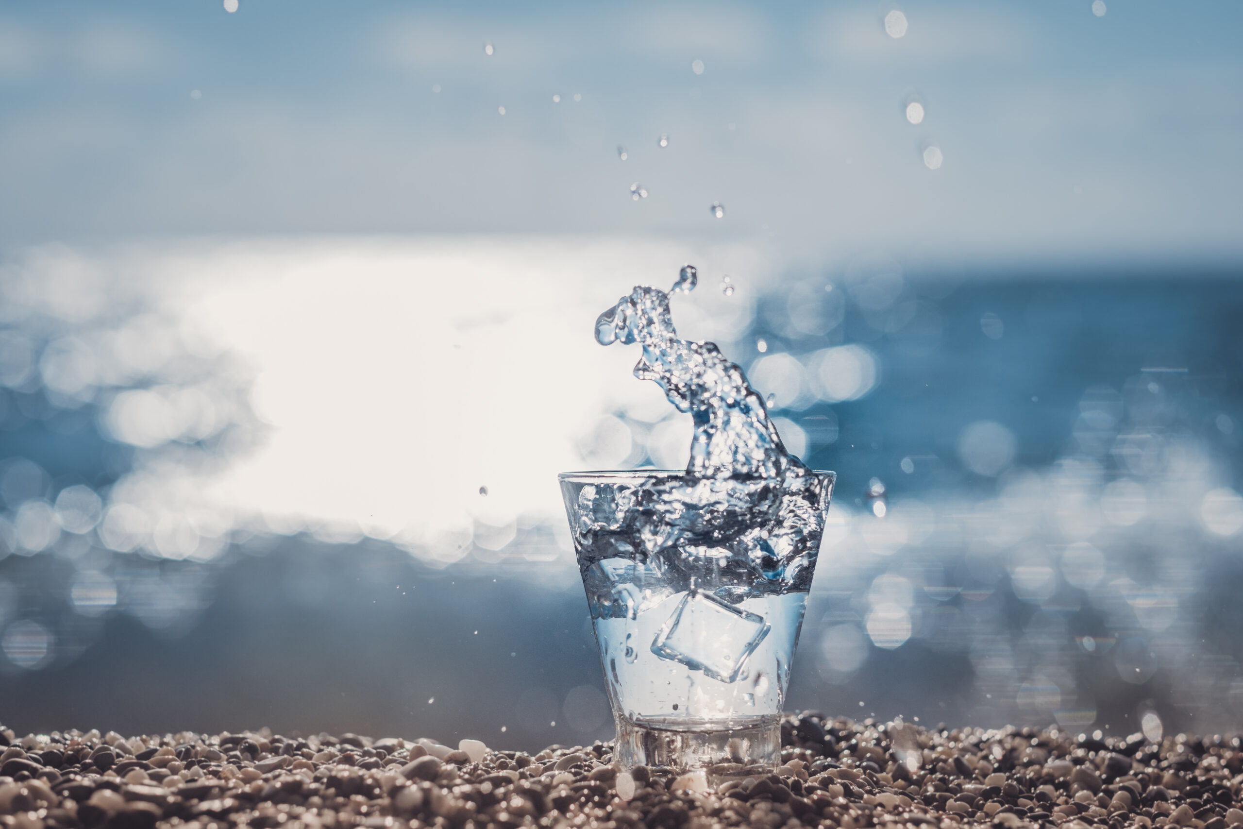 splashing water in a glass by the sea